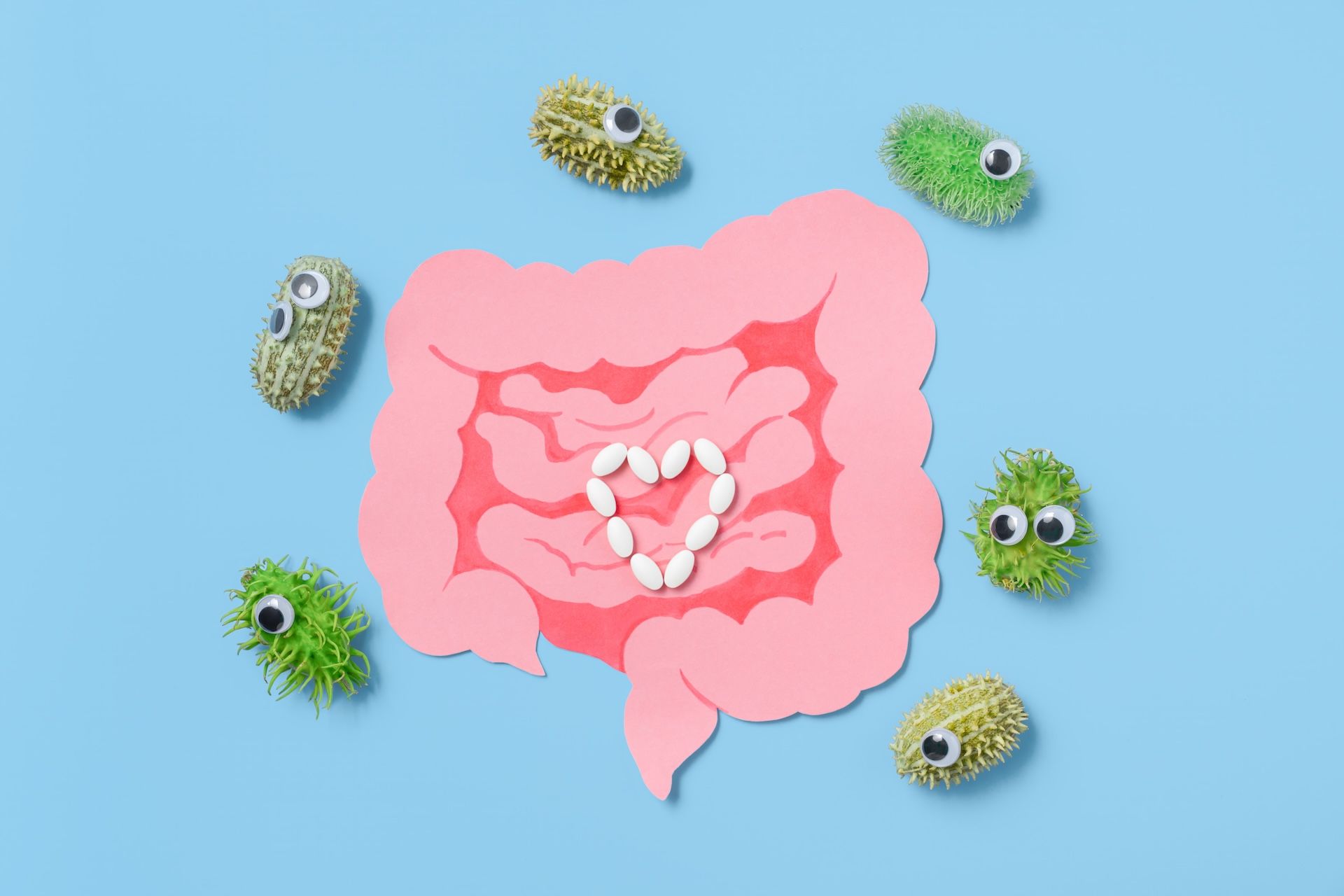 paper-gut-with-pills-and-funny-bacteria-on-blue-ba-2026-01-08-08-08-54-utc.jpg